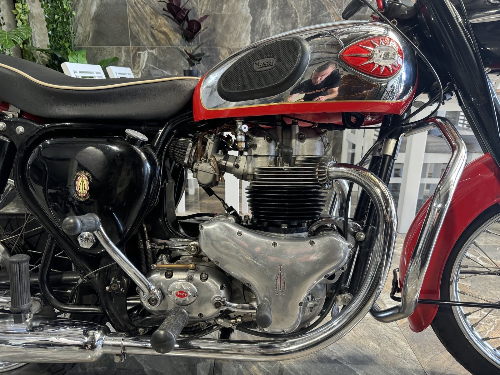 A close up of a carb motorcycle engine.