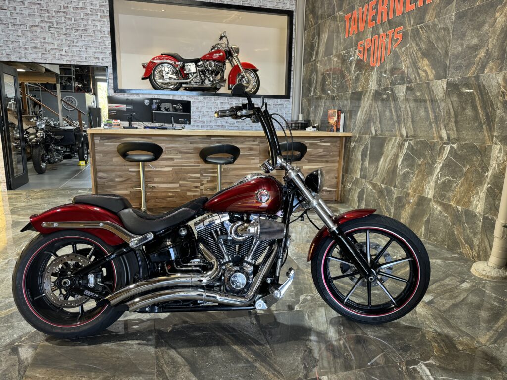 A Harley Davidson motorcycle parked in the front of the Taverner Motorsports motorcycle workshop.
