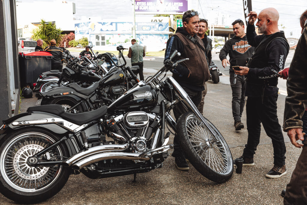 Local motorcycle enthusiasts standing in front of Taverner Motorsports motorcycle workshop.